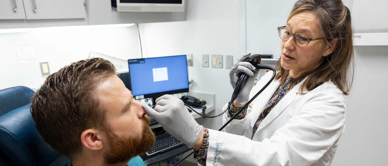 Kristi Chang, MD, in the otolaryngology clinic with simulated patient