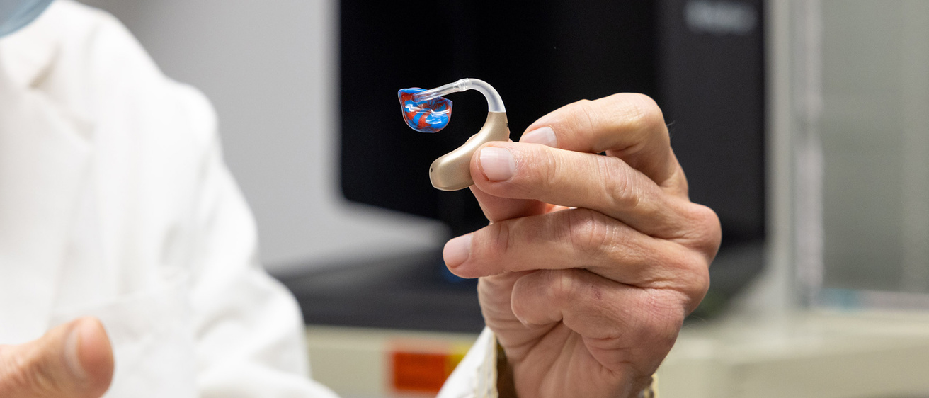 Dr. Tyler with device for ears
