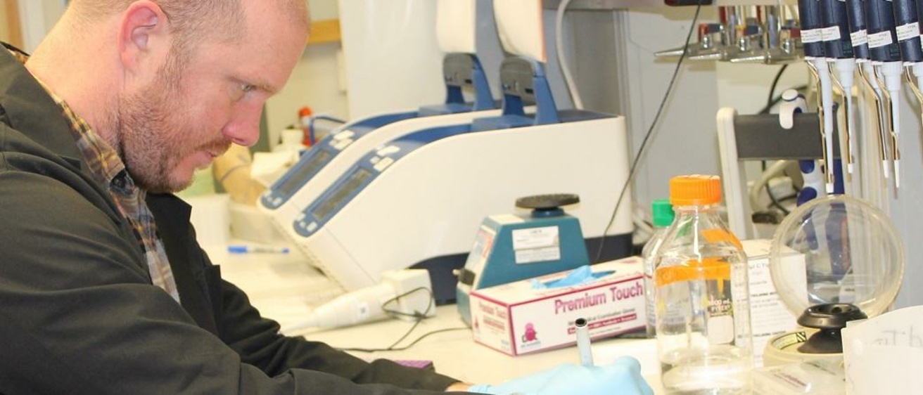 Research banner with Mike in the lab