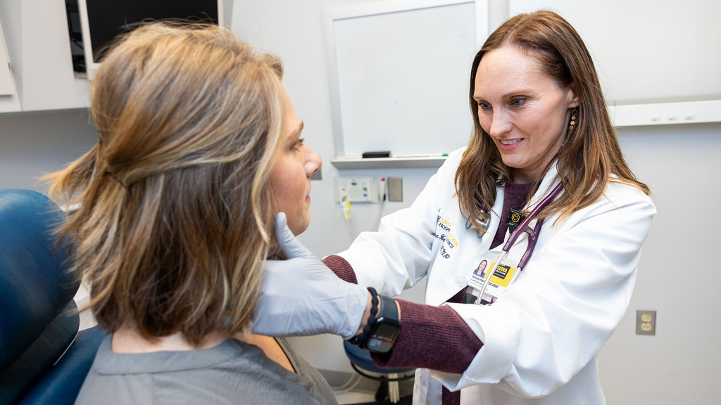 Himena Harris, ARNP, examines a simulated pediatric patient